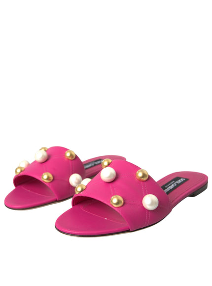 a pair of pink sandals with pearls on them