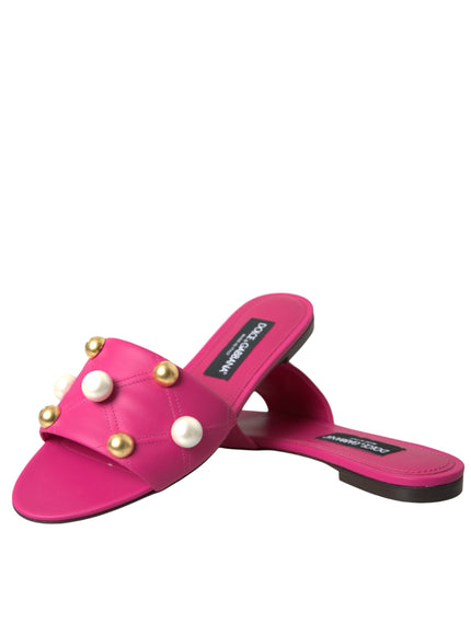 a pair of pink slippers with pearls