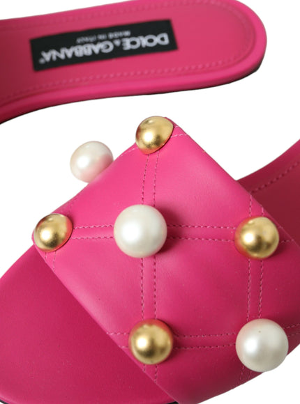 a pair of pink sandals with pearls on them