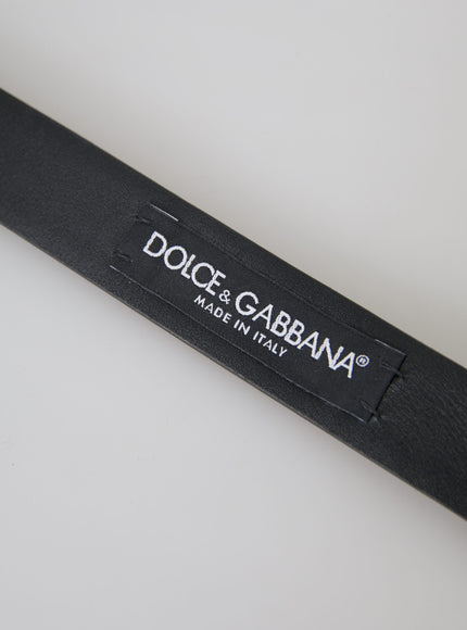 a close up of a black belt on a white surface