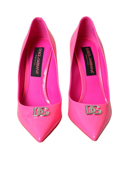 a pair of pink high heels with a logo on the heel