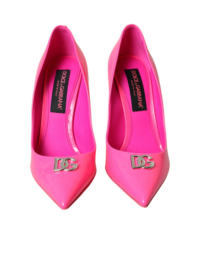 a pair of pink high heels with a logo on the heel