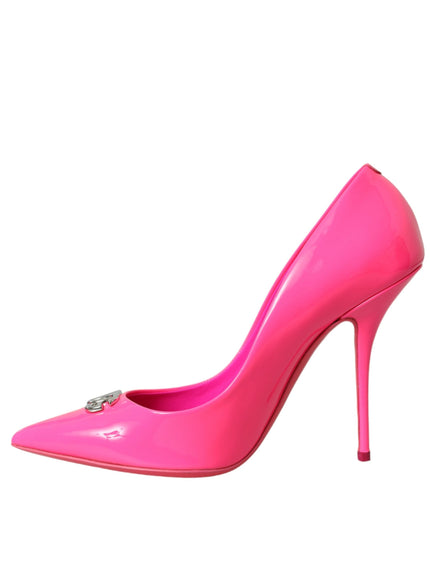 a pink high heeled shoe with a metal buckle