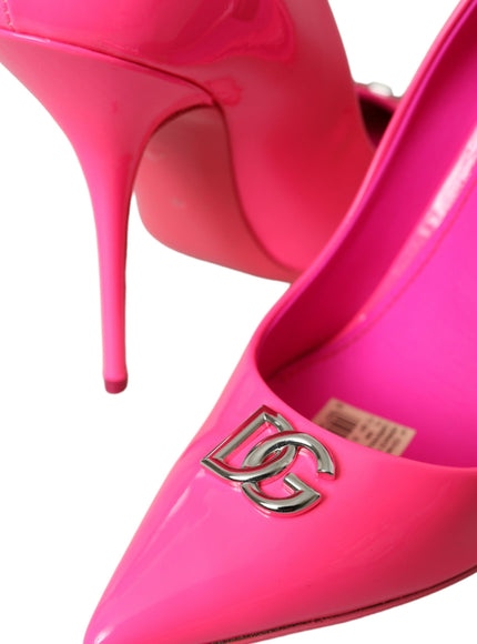 a pair of pink high heels with a logo on the heel