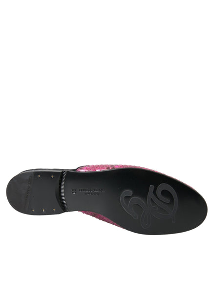 a pair of black and pink shoes on a white background