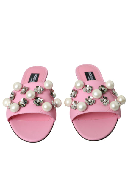 a pair of pink slippers with pearls on them