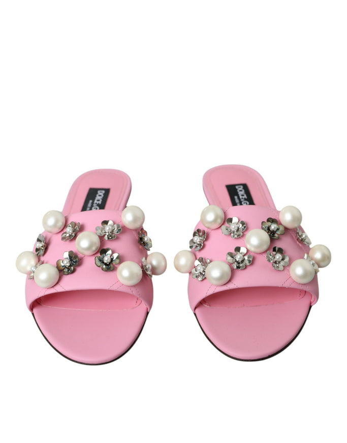 a pair of pink slippers with pearls on them