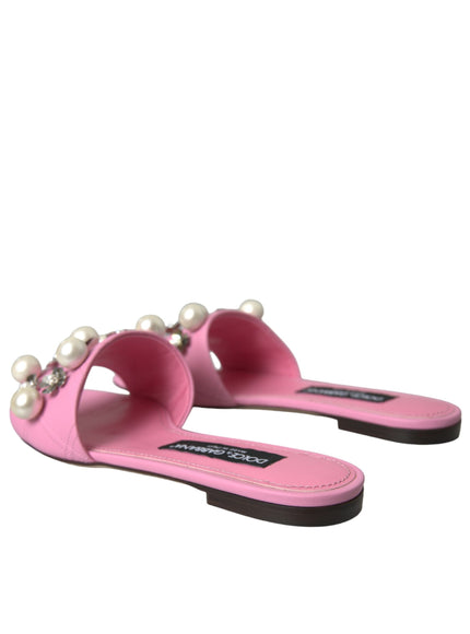 a pair of pink sandals with pearls on the toes