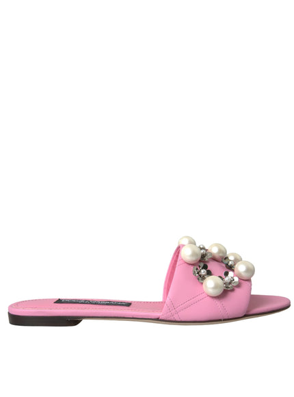 a pair of pink sandals with pearls on the toes