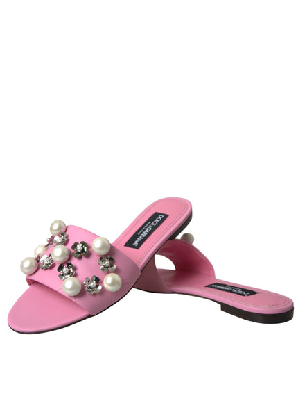 a pair of pink slippers with pearls on them