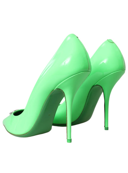 a pair of green high heeled shoes on a white background