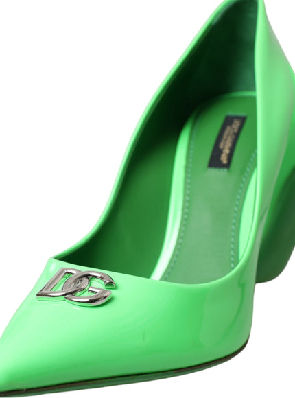 a pair of green shoes with a metal buckle