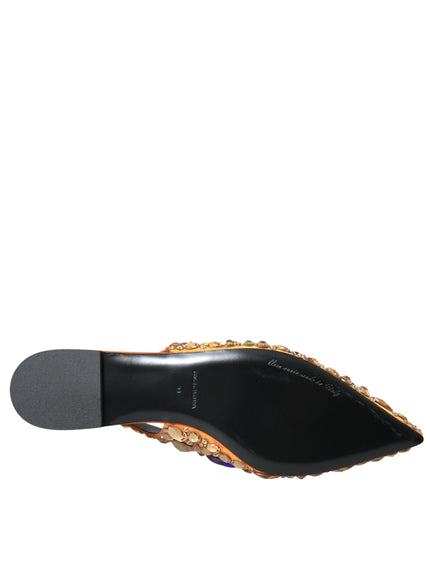 a pair of black and gold shoes on a white background