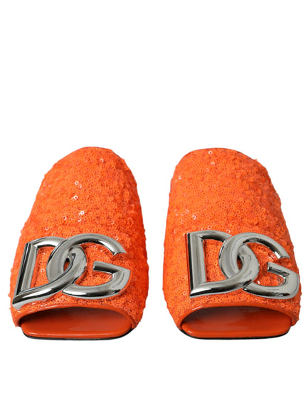 a pair of orange slippers with a silver logo