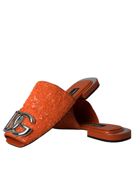 a pair of orange slippers with a silver buckle