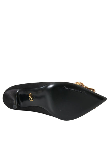 a black shoe with a gold chain on it