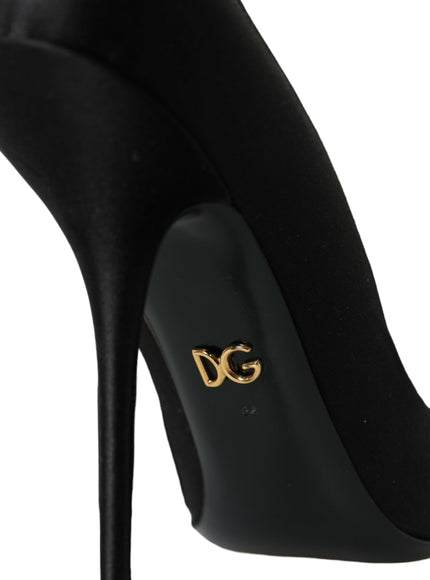 a black high heeled shoe with a gold logo