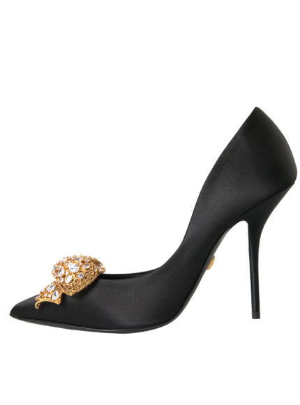 a black high heel shoe with a gold buckle