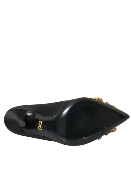 a close up of a black shoe with a gold chain