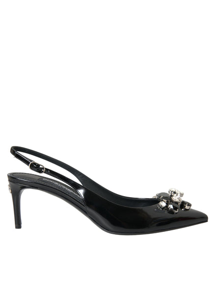 a pair of black shoes with a bow on the heel