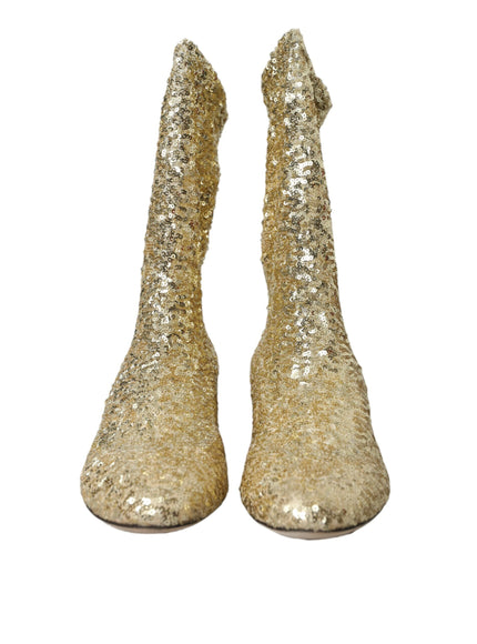 a pair of gold glittered shoes on a white background