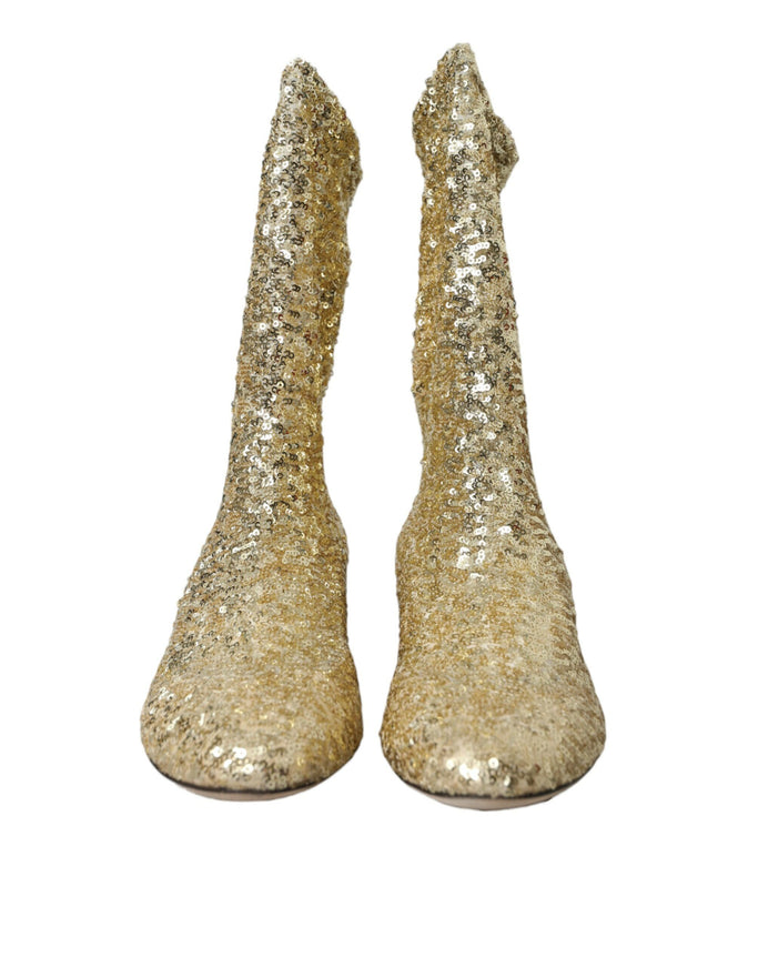 a pair of gold glittered shoes on a white background