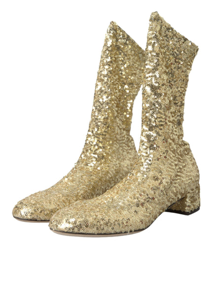 a pair of gold sequin boots on a white background