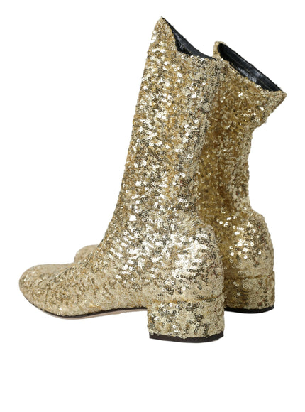 a pair of gold sequin boots on a white background