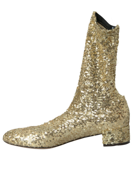 a pair of gold sequin boots on a white background