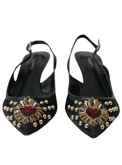 a pair of black high heeled shoes with gold and red beading