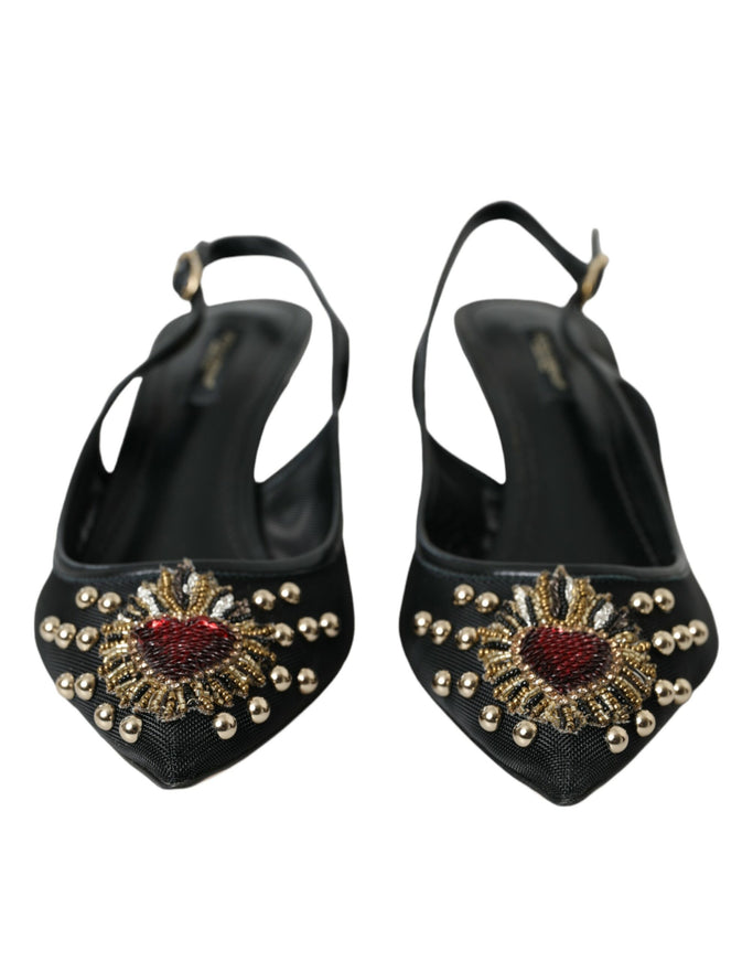 a pair of black high heeled shoes with gold and red beading