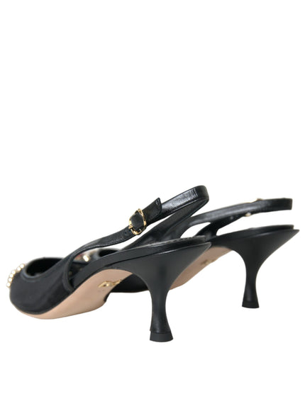 a pair of black high heels with a gold buckle