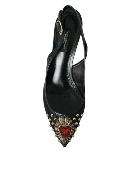 a pair of black high heels with a heart on the heel