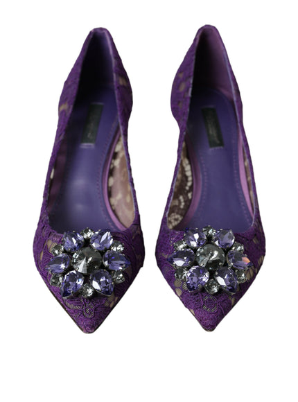 a pair of purple shoes with a jeweled buckle