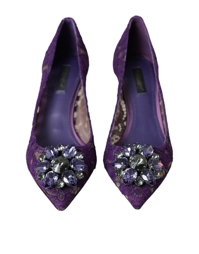 a pair of purple shoes with a jeweled buckle