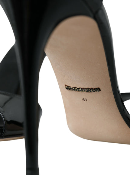 a pair of black high heels with a gold logo