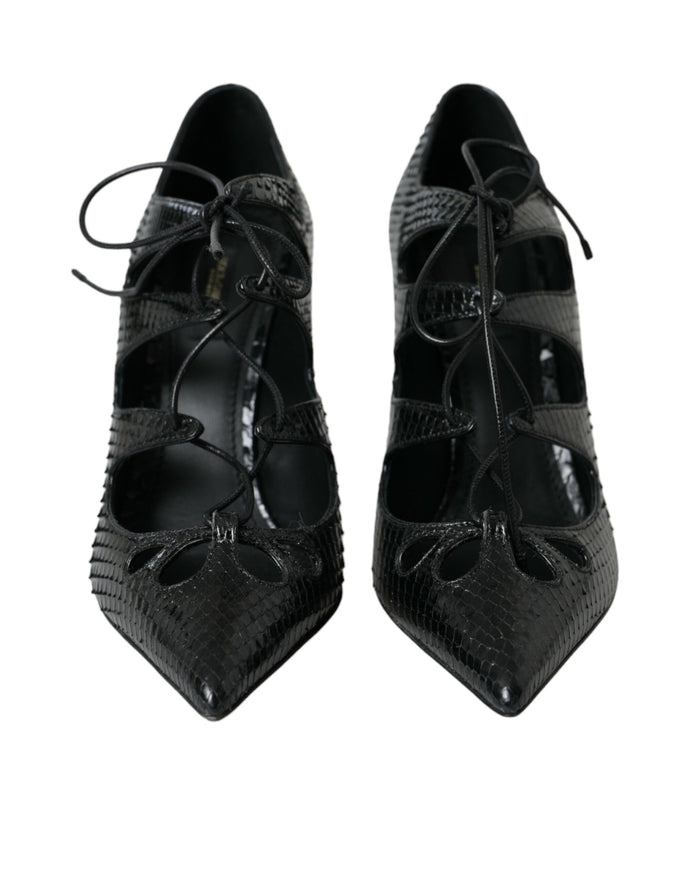 a pair of black shoes with laces on them