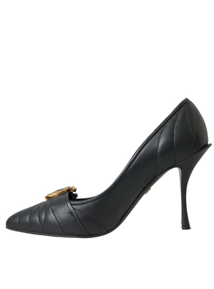 a black high heeled shoe with a gold chain