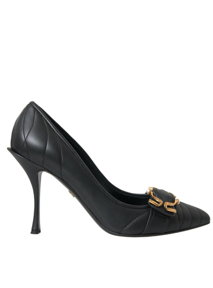 a black high heeled shoe with a gold buckle