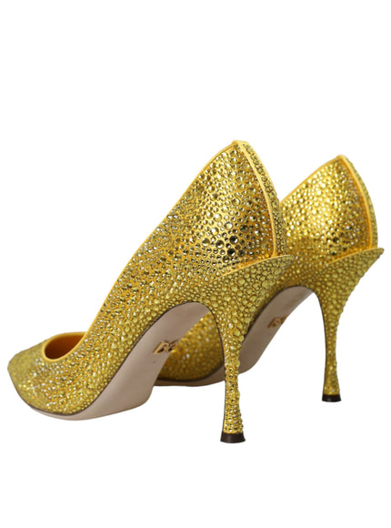 a pair of gold high heeled shoes on a white background