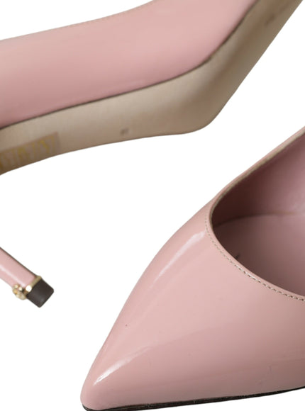 a pair of pink high heels with a cigarette sticking out of the heel