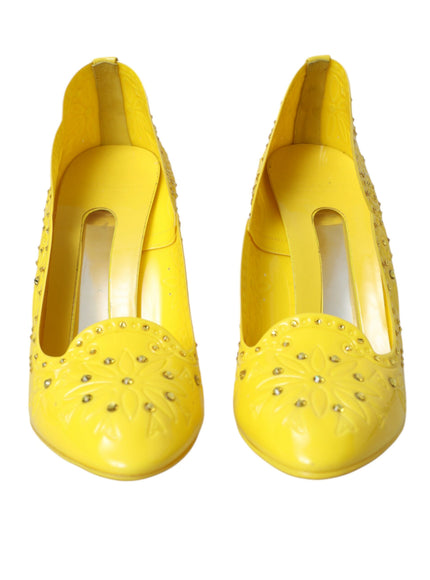 a pair of yellow shoes with studdings on them