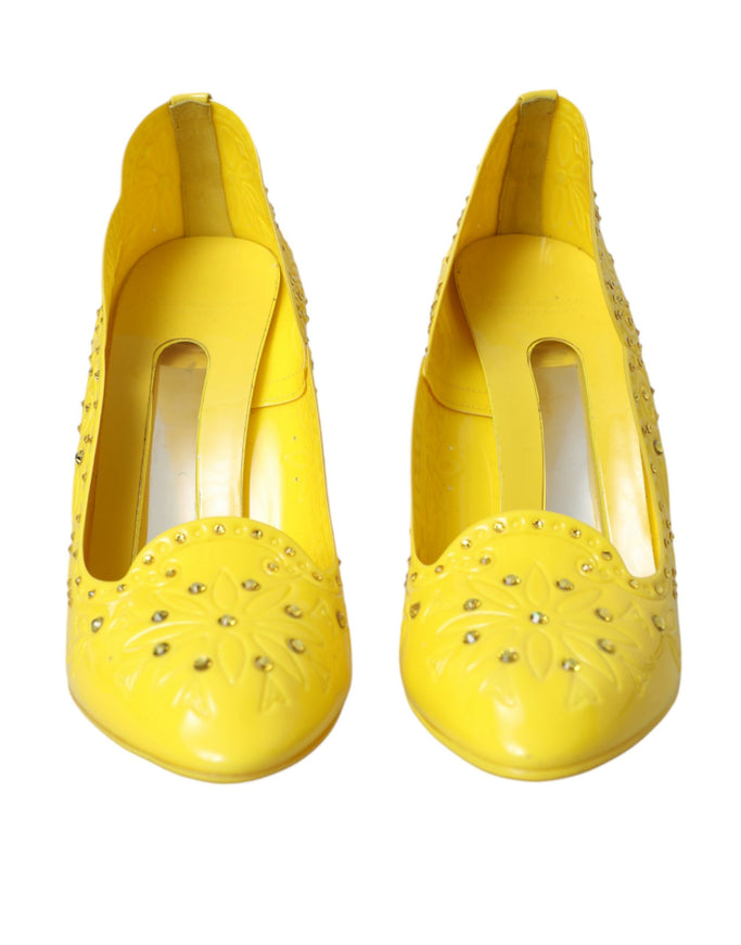 a pair of yellow shoes with studdings on them