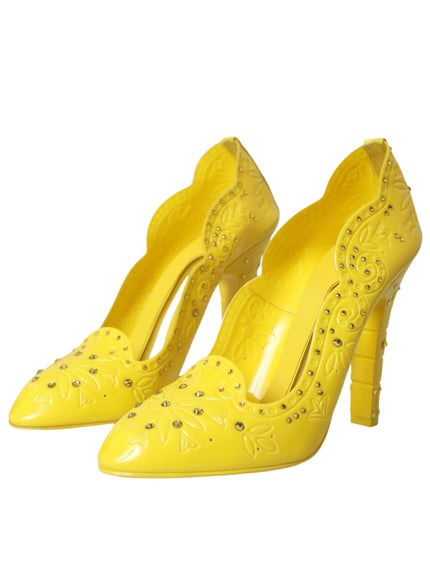 a pair of yellow high heeled shoes on a white background