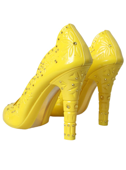 a pair of yellow high heeled shoes on a white background