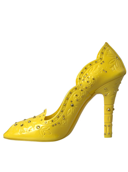 a yellow high heeled shoe with rivets