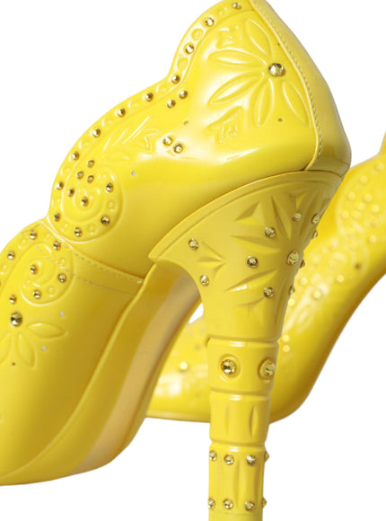 a pair of yellow high heeled shoes on a white background