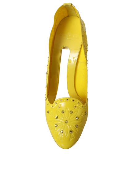 a pair of yellow high heels with studded details