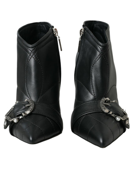 a pair of black boots with chains on them