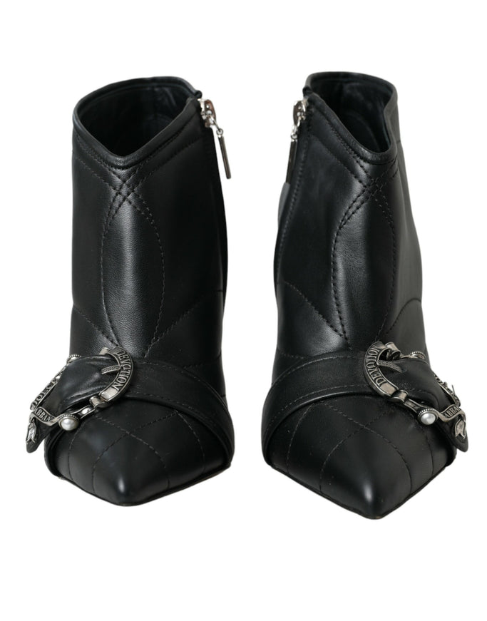 a pair of black boots with chains on them